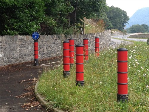 red plastic bollards on pathway