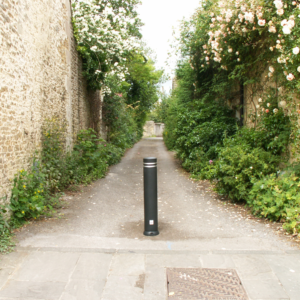black plastic bollard on pedestrian path