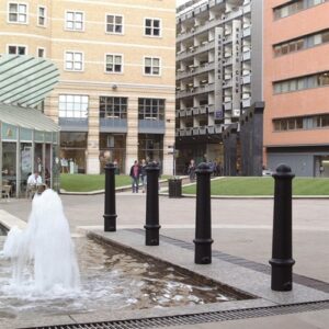 black plastic bollards near a fountain